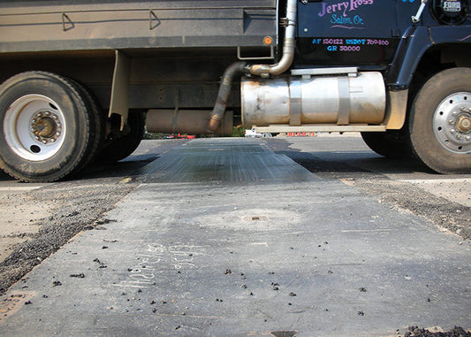 Truck crossing an EZY STEEL steel road plate
